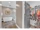 Bathroom featuring soaking tub, glass-enclosed shower, and view to walk-in closet at 1716 Aberdour Dr, Apex, NC 27502