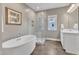 Modern bathroom featuring a glass shower, soaking tub, and double vanity at 1716 Aberdour Dr, Apex, NC 27502