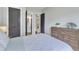 Light and airy bedroom featuring a bed with white and blue bedding and decor at 1716 Aberdour Dr, Apex, NC 27502