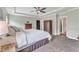 Spacious bedroom featuring tray ceiling, ceiling fan, neutral color palette, and carpeted floors at 1716 Aberdour Dr, Apex, NC 27502