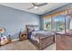 Cozy bedroom featuring a ceiling fan and a large window overlooking the neighborhood at 1716 Aberdour Dr, Apex, NC 27502