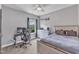 Inviting bedroom features a cozy bed, a work space and a window with view to green trees at 1716 Aberdour Dr, Apex, NC 27502