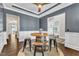 Stylish dining area with a barrel table, dark walls and white trim at 1716 Aberdour Dr, Apex, NC 27502