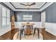Elegant dining room with a unique barrel table, designer ceiling, and wood flooring at 1716 Aberdour Dr, Apex, NC 27502