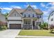 Charming two-story home featuring manicured lawn, wood accents, and an attached two-car garage at 1716 Aberdour Dr, Apex, NC 27502