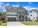 Beautifully designed home with a covered porch, an attached garage, and a lush, green lawn at 1716 Aberdour Dr, Apex, NC 27502
