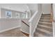 The hallway features beige carpet, white railing and walls, and large windows in the background at 1716 Aberdour Dr, Apex, NC 27502