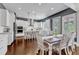 Stunning eat-in kitchen with white cabinets, island seating, stainless appliances and stylish pendant lighting at 1716 Aberdour Dr, Apex, NC 27502