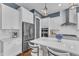 Well-lit kitchen with stainless steel appliances, island, and stylish fixtures at 1716 Aberdour Dr, Apex, NC 27502