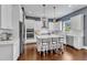 Modern eat-in kitchen featuring a kitchen island, stainless appliances, white cabinets, and open layout at 1716 Aberdour Dr, Apex, NC 27502