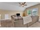 Upstairs living area showcases a sectional couch, a TV, and a window for natural light at 1716 Aberdour Dr, Apex, NC 27502