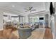 Spacious living room with hardwood floors, a large sectional, and an open floorplan at 1716 Aberdour Dr, Apex, NC 27502
