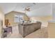 Cozy upstairs living room features plush couch, a ceiling fan, and a sunlit window at 1716 Aberdour Dr, Apex, NC 27502