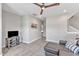 Loft features a sectional couch, TV, and views to the rest of the home at 1716 Aberdour Dr, Apex, NC 27502
