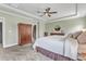 Serene main bedroom with tray ceilings, dresser, and carpeted floors at 1716 Aberdour Dr, Apex, NC 27502