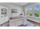 Bright home office with lots of natural light, built-in bookcase, and neutral blue walls at 1716 Aberdour Dr, Apex, NC 27502