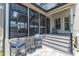 Screened-in porch with comfortable seating, a small table, and easy access to the backyard at 1716 Aberdour Dr, Apex, NC 27502