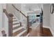 Open stairway to living room with hardwood floors, white spindles and wood banister at 1716 Aberdour Dr, Apex, NC 27502