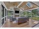Inviting sunroom with vaulted wood ceiling, stone fireplace, and scenic outdoor views at 1716 Aberdour Dr, Apex, NC 27502