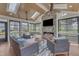 Cozy sunroom with stone fireplace, vaulted ceiling, and comfortable seating arrangement at 1716 Aberdour Dr, Apex, NC 27502