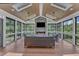 Relaxing sunroom with stone fireplace, wood ceiling, and expansive windows overlooking the yard at 1716 Aberdour Dr, Apex, NC 27502