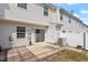 Exterior shot of a backyard with a patio, sliding glass doors, and AC unit at 1966 Grassy Banks Dr, Raleigh, NC 27610