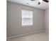 Carpeted bedroom with a window, ceiling fan, and a neutral color scheme at 1966 Grassy Banks Dr, Raleigh, NC 27610