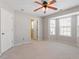 Spacious bedroom with plush carpeting, ceiling fan, and lots of natural light at 1966 Grassy Banks Dr, Raleigh, NC 27610