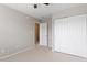 A carpeted bedroom with a closet and a doorway that leads to other rooms at 1966 Grassy Banks Dr, Raleigh, NC 27610