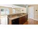 Open kitchen with stainless steel sink, wooden cabinets, and a view into the living area at 1966 Grassy Banks Dr, Raleigh, NC 27610