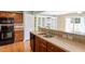 Open kitchen featuring wood cabinets, stainless steel sink, and black appliances at 1966 Grassy Banks Dr, Raleigh, NC 27610