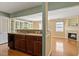 Open-concept kitchen with wood cabinets flowing into a sunlit living area and fireplace at 1966 Grassy Banks Dr, Raleigh, NC 27610