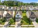 Aerial view of the home surrounded by mature trees and neighborhood homes at 2036 October Dr, Durham, NC 27703