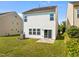 Fenced backyard with well maintained lawn and exterior patio entrance at 2036 October Dr, Durham, NC 27703