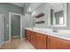 En-suite bathroom with double sink vanity, linen cabinets and tiled floor at 2036 October Dr, Durham, NC 27703