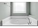 A relaxing soaking tub is featured in this bathroom with a window view at 2036 October Dr, Durham, NC 27703