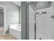 Bathroom showcases a tub and glass-enclosed shower, complemented by neutral wall colors and tile flooring at 2036 October Dr, Durham, NC 27703
