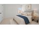 A staged bedroom with a large window, neutral decor and a queen-sized bed at 2036 October Dr, Durham, NC 27703