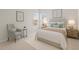 A staged bedroom with a chair, queen size bed, and two windows at 2036 October Dr, Durham, NC 27703