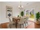 Bright dining room with modern chandelier, stylish decor, and sliding door access to backyard at 2036 October Dr, Durham, NC 27703