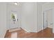 Bright entryway featuring hardwood floors, a white door, and neutral walls at 2036 October Dr, Durham, NC 27703