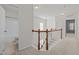 Hallway showcases a staircase with wood railing, carpeted floors, and access to a bathroom at 2036 October Dr, Durham, NC 27703