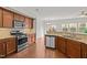 Updated kitchen with stainless steel appliances, granite counters, and an open layout into the dining room at 2036 October Dr, Durham, NC 27703