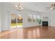Open living room boasts hardwood floors, a fireplace, and sliding doors providing access to the backyard at 2036 October Dr, Durham, NC 27703