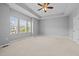 Spacious main bedroom features tray ceilings, carpeted floors and bright windows at 2036 October Dr, Durham, NC 27703