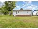 Backyard featuring green grass and the side of a white house with brick accents at 205 Person St, Oxford, NC 27565