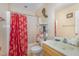 Bathroom featuring a shower with a red curtain and vanity sink at 205 Person St, Oxford, NC 27565