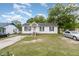 A quaint single-Gathering home with white siding and a green lawn, evoking a sense of suburban tranquility at 205 Person St, Oxford, NC 27565