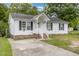 Inviting single-story home featuring a cozy front porch and a well-maintained lawn at 205 Person St, Oxford, NC 27565
