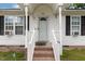 Close-up of the front porch with brick steps, white railings, and a welcoming entrance to the home at 205 Person St, Oxford, NC 27565